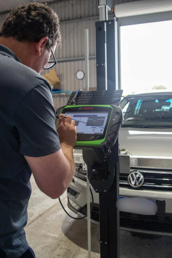 Ben, Owner of South West Windscreens performing ADAS calibration using Bosch equipment in Busselton workshop.
