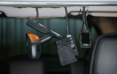 Close-up view of a modern vehicle's internal ADAS camera and sensor housing near the rear-vision mirror, highlighting the technology that requires recalibration after a windscreen replacement.
