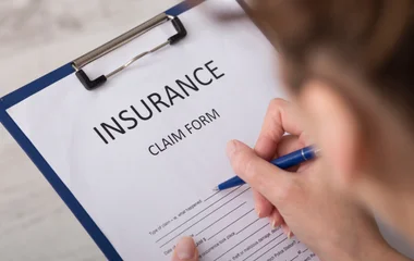 Person completing a windscreen insurance claim form — South West Windscreens & Tint manages glass claims directly with most Australian insurers on behalf of customers.