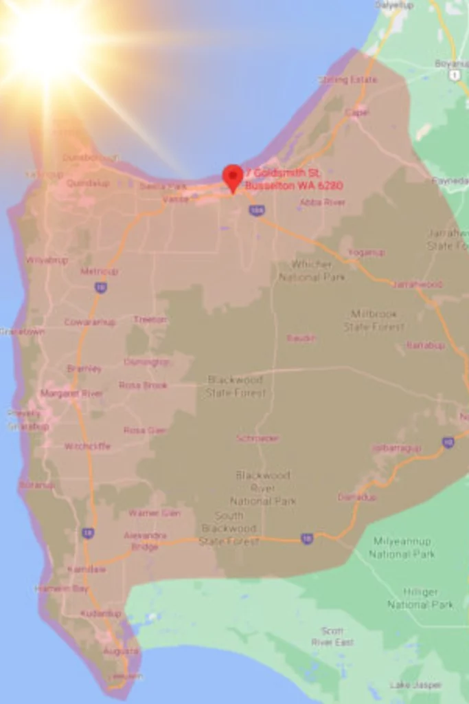 Map of the South West WA region showing the South West Windscreens & Tint service area highlighted in a shaded overlay, with a red map pin marking the workshop location at 7 Goldsmith Street Busselton WA 6280, and a sun flare in the upper left corner representing the region's intense summer heat.